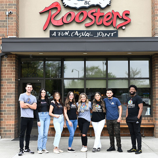 Roosters Employees in front of store