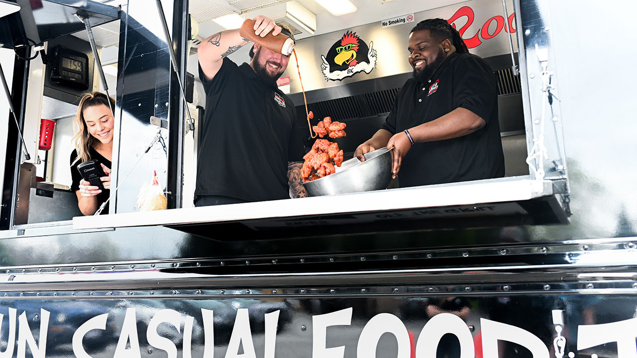 Roosters employees tossing wings